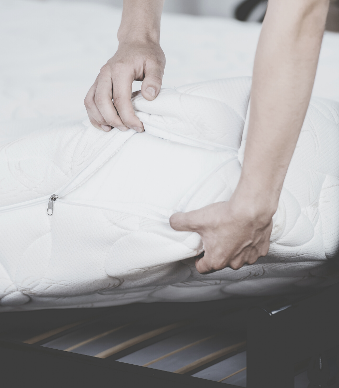 mattress being pulled off of a bed